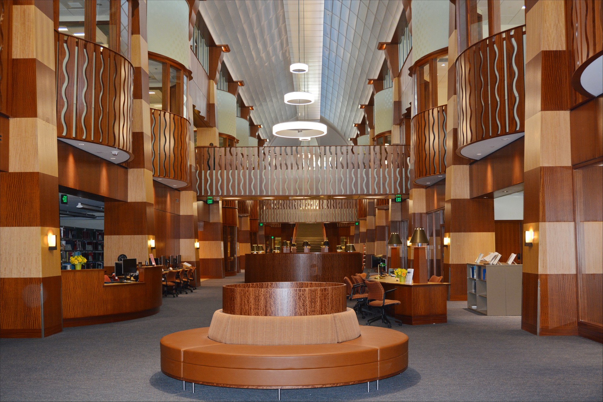 L'atrium de l'école de droit de l'Université Quinnipiac : balcons et colonnes en bois, une banquette circulaire au centre